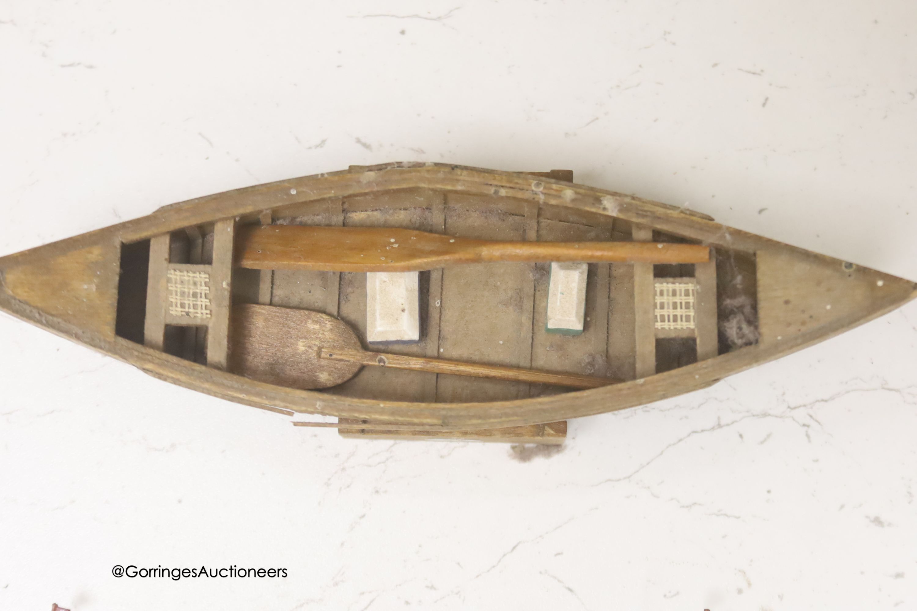 A clinker-built wood rowing boat, 41cm, and four smaller boat models